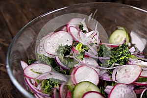 Grilled salmon with radish and spinach, served on wooden table. View from above, top studio shot