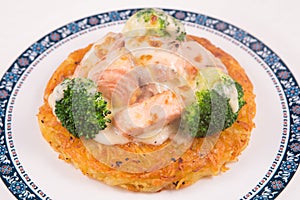 Grilled Salmon rosti with vegetables and bechamel and hollandaise