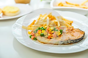 Grilled salmon steak meal served with salad