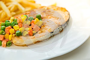 Grilled salmon steak meal served with salad