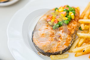 Grilled salmon steak meal served with salad