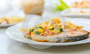 Grilled salmon steak meal served with salad