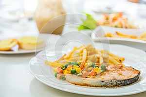 Grilled salmon steak meal served with salad