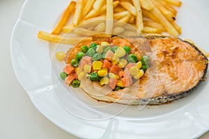 Grilled salmon steak meal served with salad