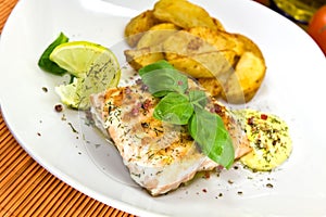 Grilled salmon steak with potato wedges