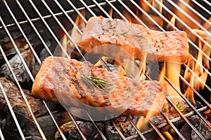 Grilled salmon steaks on the flaming