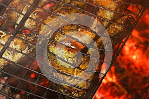 Grilled salmon steaks on a grill. Fire flame grill. Restaurant and garden kitchen.