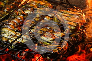 Grilled salmon steaks on a grill. Fire flame grill. Restaurant and garden kitchen.