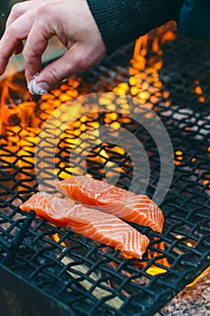 Grilled salmon steaks on a grill. Fire flame grill. Restaurant and garden kitchen. Garden party. Healthy dish.