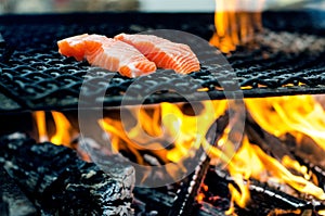 Grilled salmon steaks on a grill. Fire flame grill. Restaurant and garden kitchen. Garden party. Healthy dish.