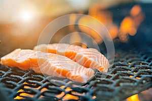 Grilled salmon steaks on a grill. Fire flame grill. Restaurant and garden kitchen. Garden party. Healthy dish.