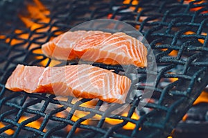 Grilled salmon steaks on a grill. Fire flame grill. Restaurant and garden kitchen. Garden party. Healthy dish.