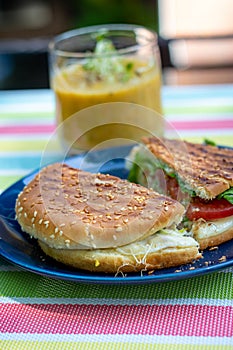 Grilled sandwich snack with soup on a terrace