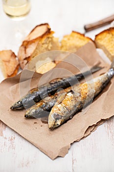 Grilled sardines with cornbread on paper