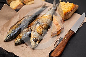 Grilled sardines with cornbread on paper