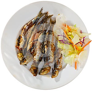 Grilled sardines served with fresh vegetable salad