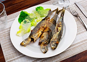 Grilled sardines served with fresh vegetable salad