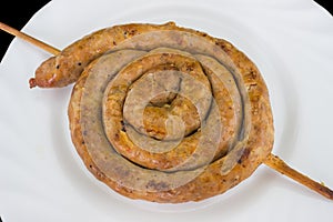 Grilled sausage laying on a clean plate