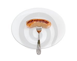 Grilled sausage in natural casing on a fork