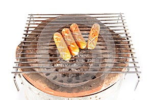 Grilled sausage over a hot barbecue grill