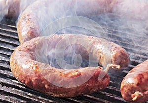 Grilled sausage and smoke around it. Traditional Bulgarian and Balkan sausage made from minced meat. B-B-Q