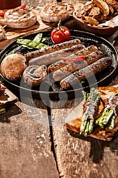 Grilled Sausage and Vegetables on Wooden Table