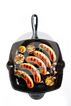 Grilled sausages on cast iron grill pan