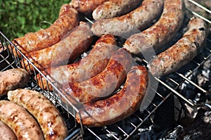 Grilled sausages. Closeup of sausage on the grill. Home-made Sausages. Bavarian sausages