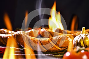 Grilled sausages on the flaming grill