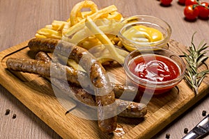 Grilled sausages with french fries with ketchup and mustard