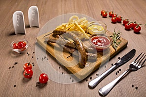 Grilled sausages with french fries with ketchup and mustard on a wooden stand