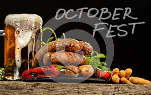 Grilled sausages with a glass of beer on a wooden table