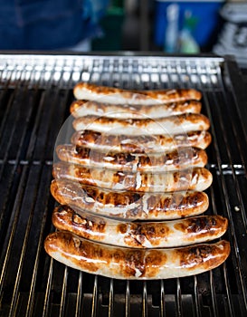 Grilled sausages on grill in a street market