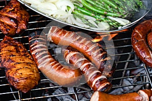 Grilled sausages and meat with vegetables