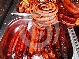 Grilled sausages and pork roasts