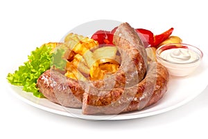 Grilled sausages with potatoes fries solated on white background