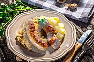 Grilled sausages, potatoes and sauerkraut