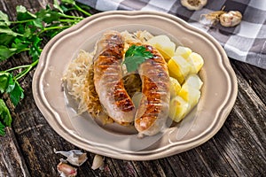 Grilled sausages, potatoes and sauerkraut