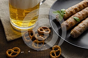 Grilled sausages with pretzels and mugs of beer