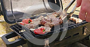 Grilled sausages roasting on barbecue grill outdoors. Dynamic video grilled food fried, smoked in charcoal grills. Turns