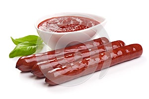 Grilled sausages with tomatoes sauce and fresh herbs, isolated on white background