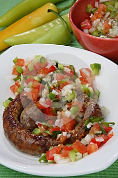 Grilled sausages with vegetable sauce