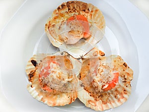 Grilled scallops shell with butter and cheese.