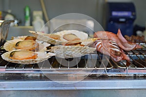 Grilled scallops and squids on a roaster in beer festival, Japan