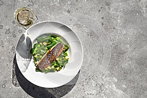 Grilled sea bass fillet and avocado with green beans, delicious diet food.