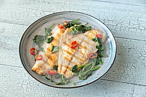 Grilled sea bream fish fillet with spinach