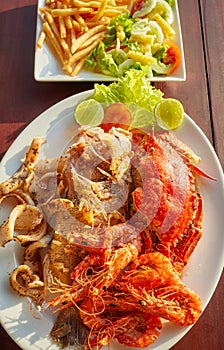 Grilled seafood platter with crab, fish, prawn and squid with lemon