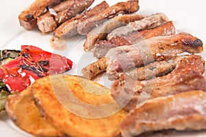 Grilled Secreto of Spanish Iberico pork cut with potatoes and grilled vegetables photo