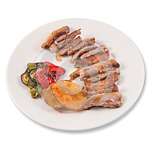 Grilled Secreto of Spanish Iberico pork cut with potatoes and grilled vegetables photo