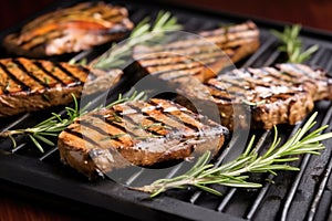 grilled seitan steaks with rosemary sprig garnish